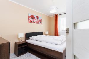 Posteľ alebo postele v izbe v ubytovaní Apartments Kraków Zablocie by Noclegi Renters