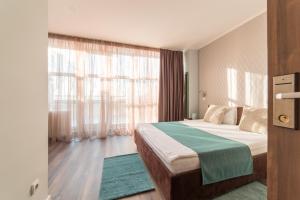 Кровать или кровати в номере Balkan Hotel Garni