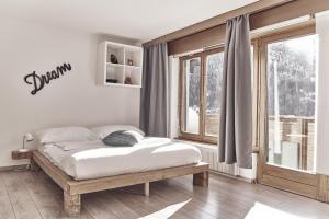 Postel nebo postele na pokoji v ubytování Hotel Marmotte + 26 fotografií