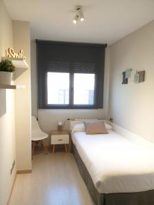Posteľ alebo postele v izbe v ubytovaní Apartamentos Real Lleida