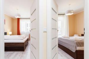 Posteľ alebo postele v izbe v ubytovaní Apartments Kraków Zablocie by Noclegi Renters