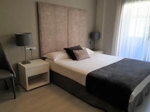 Posteľ alebo postele v izbe v ubytovaní Apartamentos Real Lleida