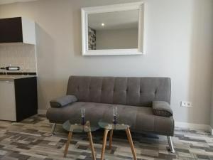 a living room with a couch and two tables at RANDMAR APARTMENT COSTA DEL SOL in Benalmádena