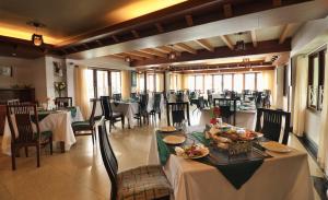 a dining room with tables and chairs with food on them at Zone Connect by The Park Mount Siniolchu, Gangtok in Gangtok