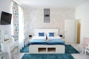 a bedroom with a bed and a blue rug at Kaya Home in Sibiu