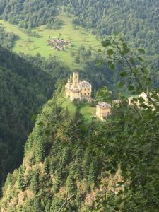 a castle on the side of a mountain at a magic retreat in Fobello