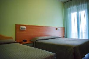 Postel nebo postele na pokoji v ubytování Hotel Martinez