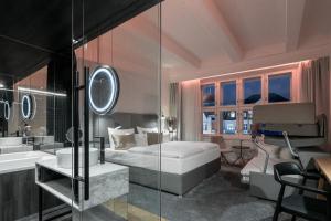 a bedroom with a bed and a shower and a sink at Pytloun Boutique Hotel Prague in Prague