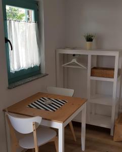 a table and chairs in a room with a window at Country house in Ankaran +13 photos
