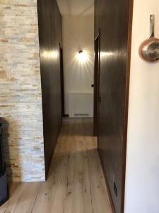 a hallway with a metal elevator and a brick wall at a magic retreat in Fobello