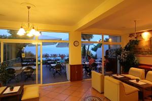 a restaurant with a view of the ocean at Hotel Stanger in Lovran
