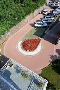an aerial view of a large flower clock in a parking lot at Hotel Stanger in Lovran