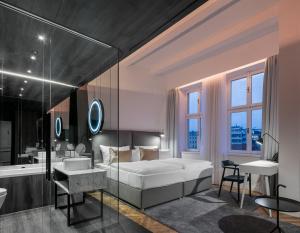 a bedroom with a bed and a tub and a sink at Pytloun Boutique Hotel Prague in Prague