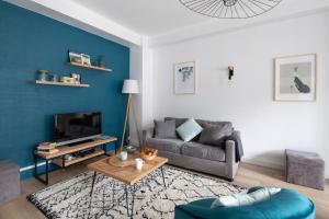 a living room with a couch and a table at L'Anémone in Saint Malo +11 photos