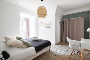 um quarto com uma cama, uma mesa e uma cadeira em L'Anémone em Saint Malo