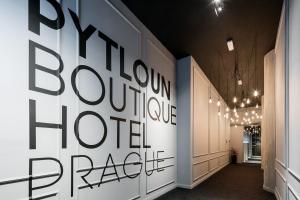 a hallway with a large black and white wall at Pytloun Boutique Hotel Prague in Prague