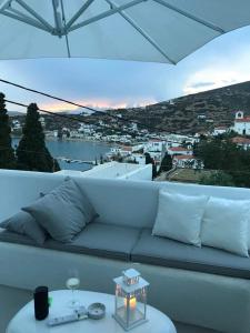 a living room with a white couch and a table at Villa Arion in Batsi