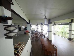 a room with tables and chairs and a dining room at Hickory Penang Hill in George Town