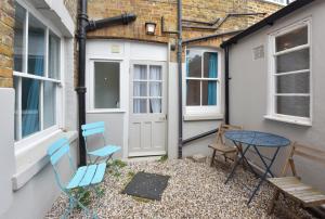 een patio met stoelen, een tafel en een deur bij Host & Stay - Victoria Gardens in Ramsgate