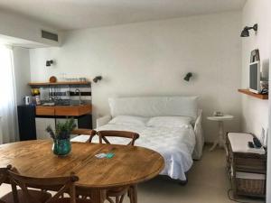 a bedroom with a bed and a wooden table and a tableablish at La Scibina in Marina di Ragusa
