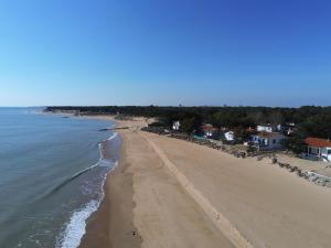 an aerial view of a beach with houses and the ocean at la GRIERE in La Tranche-sur-Mer