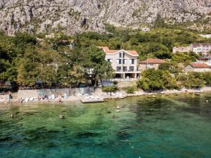 a group of people in the water at a beach at Beachfront Villa Nautica in Kotor