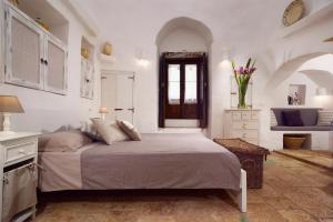Postel nebo postele na pokoji v ubytování B&B Trullo Barbagiullo