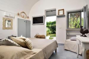 Postel nebo postele na pokoji v ubytování B&B Trullo Barbagiullo