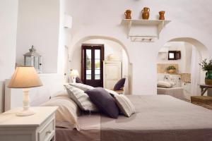 Postel nebo postele na pokoji v ubytování B&B Trullo Barbagiullo