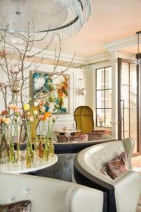 a large room with a tub and flowers on the wall at The Cadogan, A Belmond Hotel, London in London