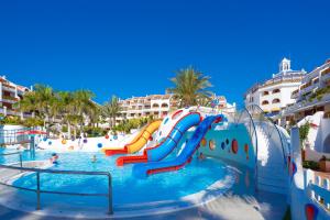 a water slide in a pool at a resort at Parque Santiago III Official in Playa de las Americas