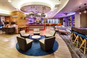 a lobby of a hotel with chairs and a bar at ibis London City - Shoreditch in London