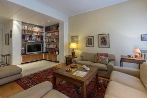 a living room with two couches and a tv at Art Deco Spacious Appartment close to centre in Athens