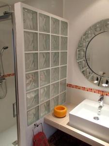 a bathroom with a sink and a mirror at La Maison du Courtil, Citron-Caramel in Moustiers-Sainte-Marie