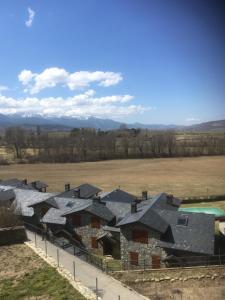 a group of houses in a field next to a fence at Cerdanya Escadarcs 2 in Escardacs