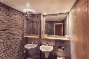 a bathroom with two sinks and a glass shower at Plato's in Kirkby Lonsdale +65 photos
