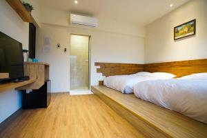 Postel nebo postele na pokoji v ubytování New Live B&B
