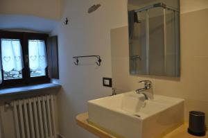 a bathroom with a sink and a mirror and a window at Il Borgo Di Monica in Domodossola +21 photos