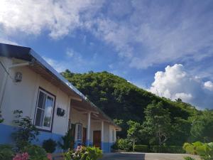 uma casa com uma colina ao fundo em Mediterranean B&B em Fushan