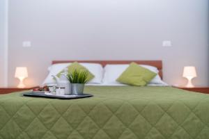 A bed or beds in a room at Green Residence
