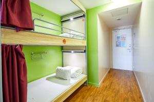 a room with green walls and bunk beds at St Christopher's Inn Paris - Canal in Paris