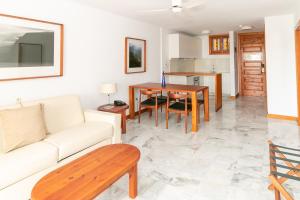 a living room with a couch and a table at Parque Santiago III Official in Playa de las Americas