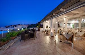 a restaurant with tables and chairs at night at Grand Hotel In Porto Cervo in Porto Cervo