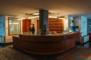 a woman talking on a cell phone at a bar at Residence Hotel Torino Uno in Turin