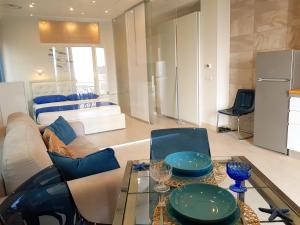 a living room with a couch and a glass table at Blue Lagune Taormina Mare in Taormina