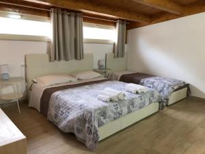 a bedroom with two beds with towels on them at B&B Le Mansarde in Pescara
