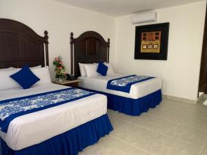 Gulta vai gultas numurā naktsmītnē Hotel Catedral Valladolid Yucatan