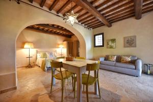 a living room with a table and a bedroom at Il Molino in Porto Ercole