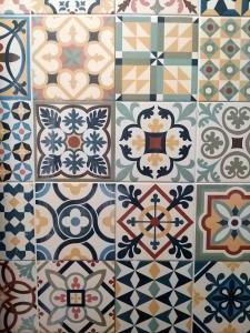 a group of different types of tiles on a wall at Orange3 Hostel in Lagos