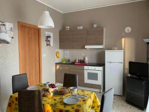 a kitchen and a table with a yellow table cloth at Corso Vittorio Emanuele Luxury house in Salerno